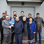 A group of people standing in front of the entrance to the treatment plant.