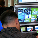 Monitor showing a recording of a presenter at the workshop.