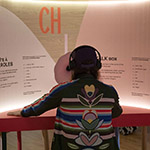 Xavier sits in front of an exhibit entitled "Talk Box" at the Musée des Abénakis.